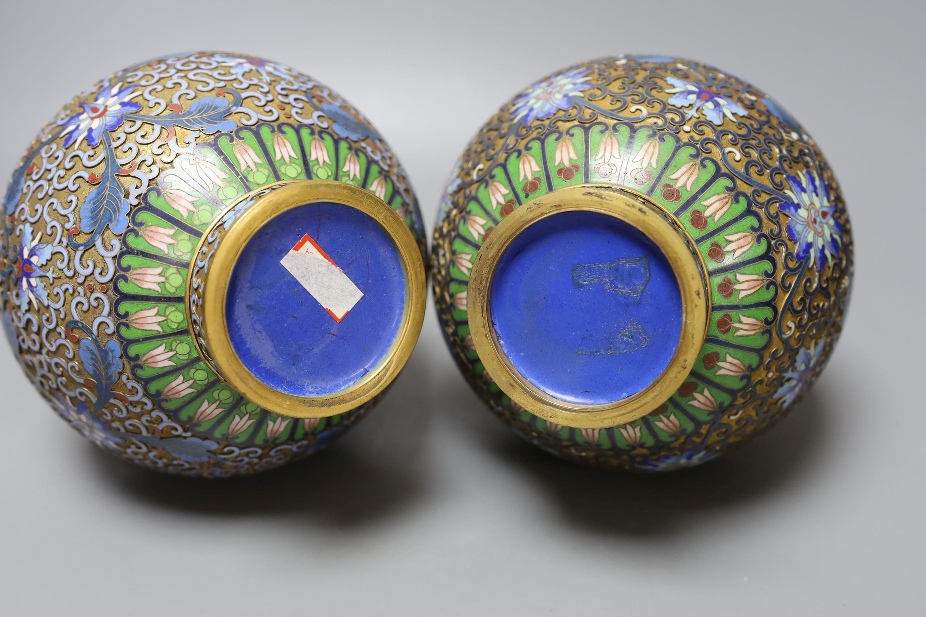 A pair of Chinese cloisonné enamel vases, on carved wood plinths, 30cm